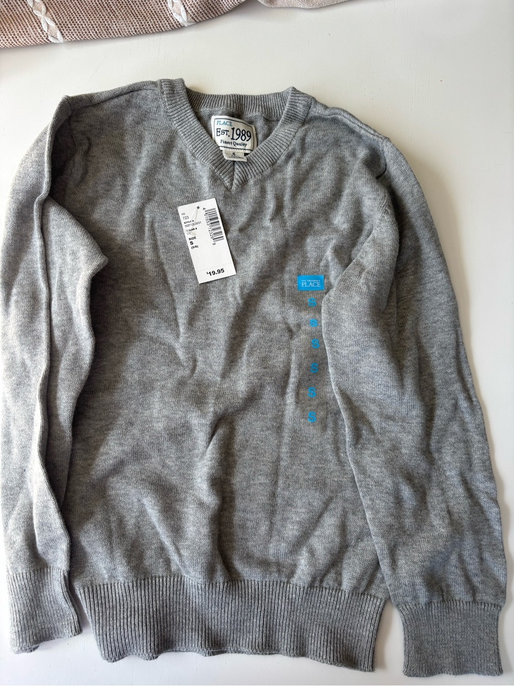 The Childrenโs Place grey v neck sweater size 5/6. NWT
